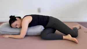 Yin Yoga Deer Twist supported with bolster